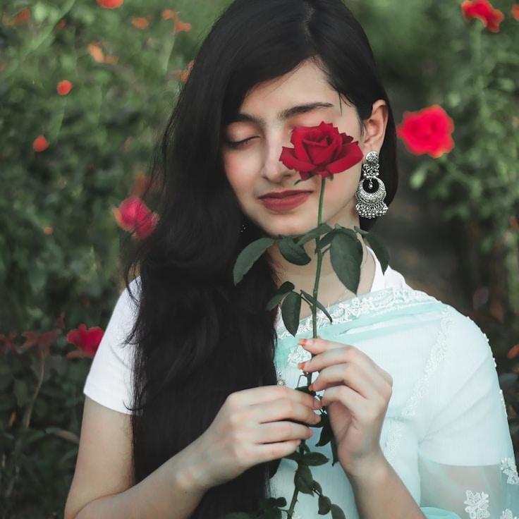 Kaveri Mehta, Lead Design Curator at HarborPaperRoom, reviewing corporate floral arrangements